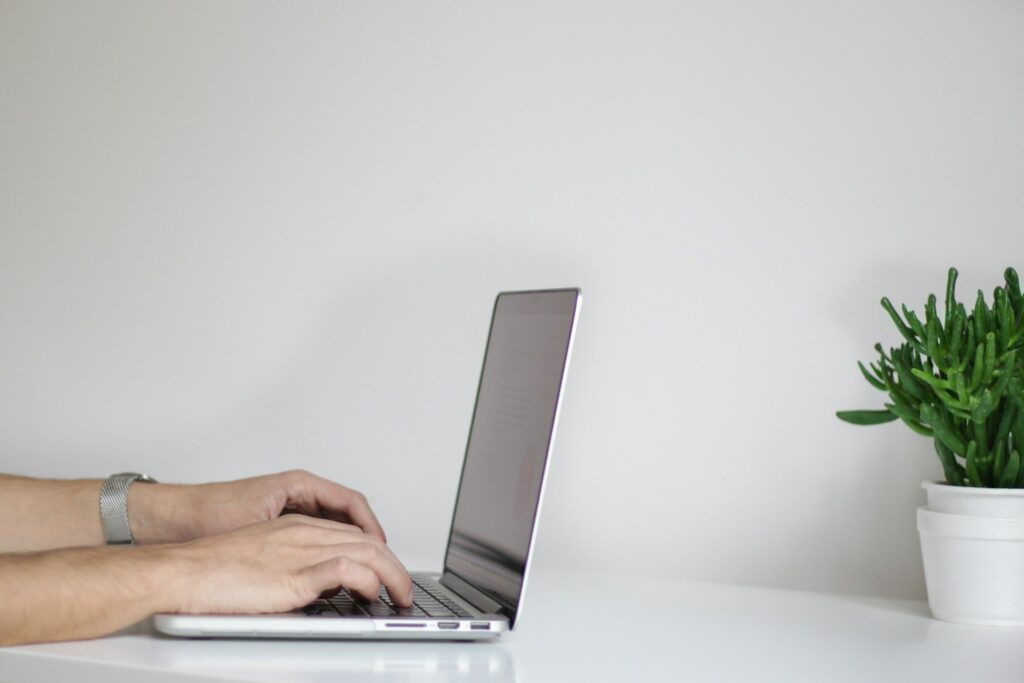 A person working on a laptop at home.